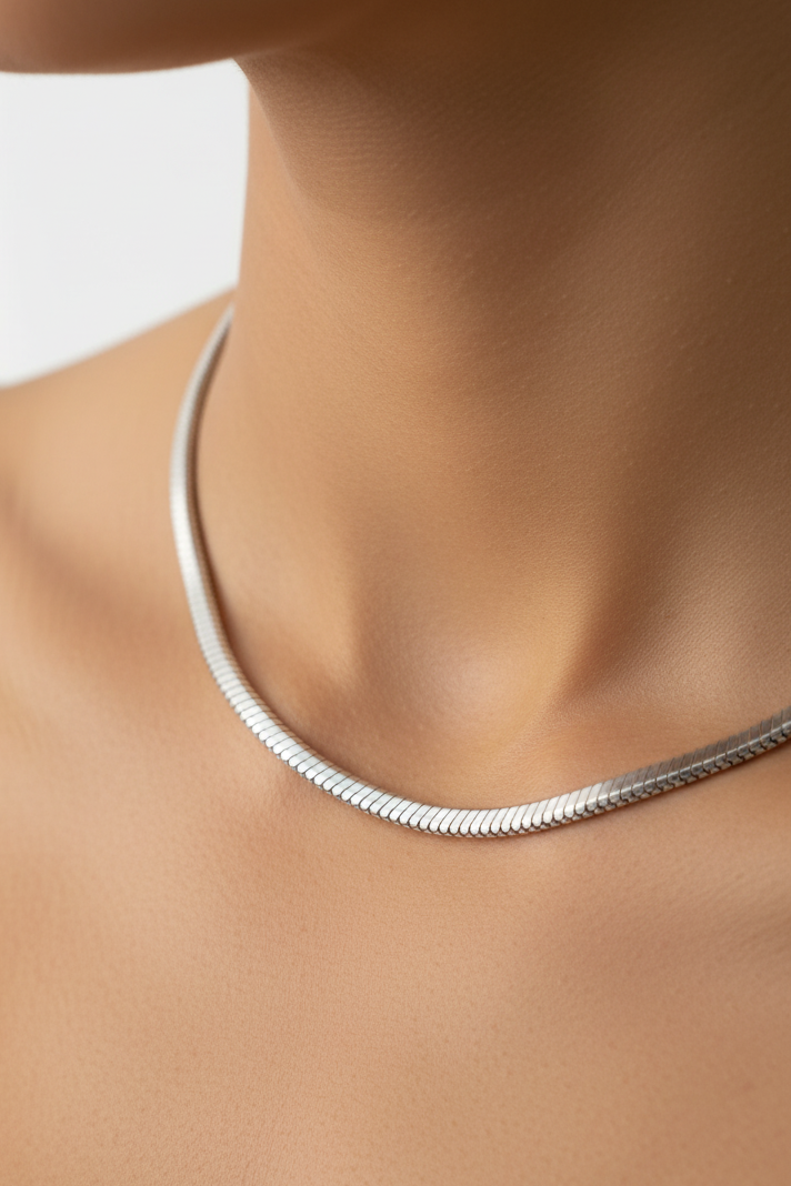 Model wearing silver snake chain necklace